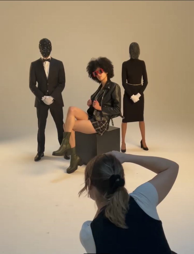 Behind the scenes on a studio set with masked figures