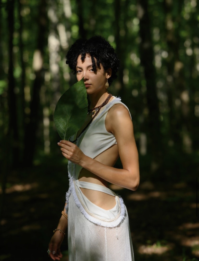Ivory cutout dress in a forest of light